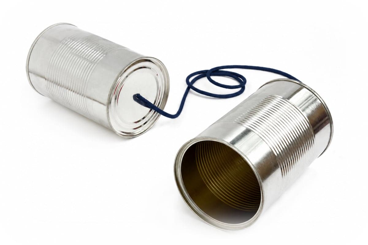 Two tin cans joined by a string: a tin can telephone.